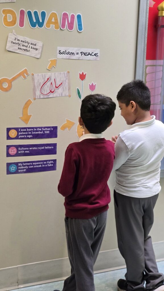 Two students reading the word salam (peace) in Diwani