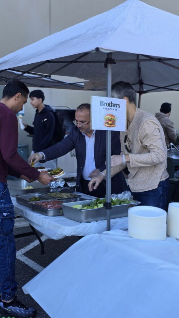 Volunteers serving food at the BBQ station