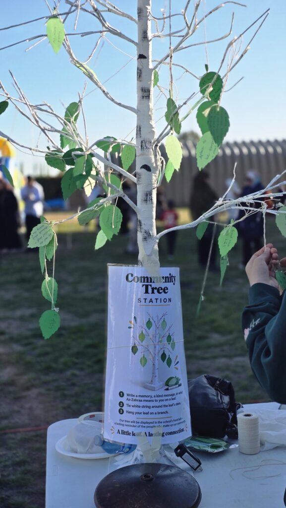 The Community Tree station, where families hung paper leaves with messages about the school