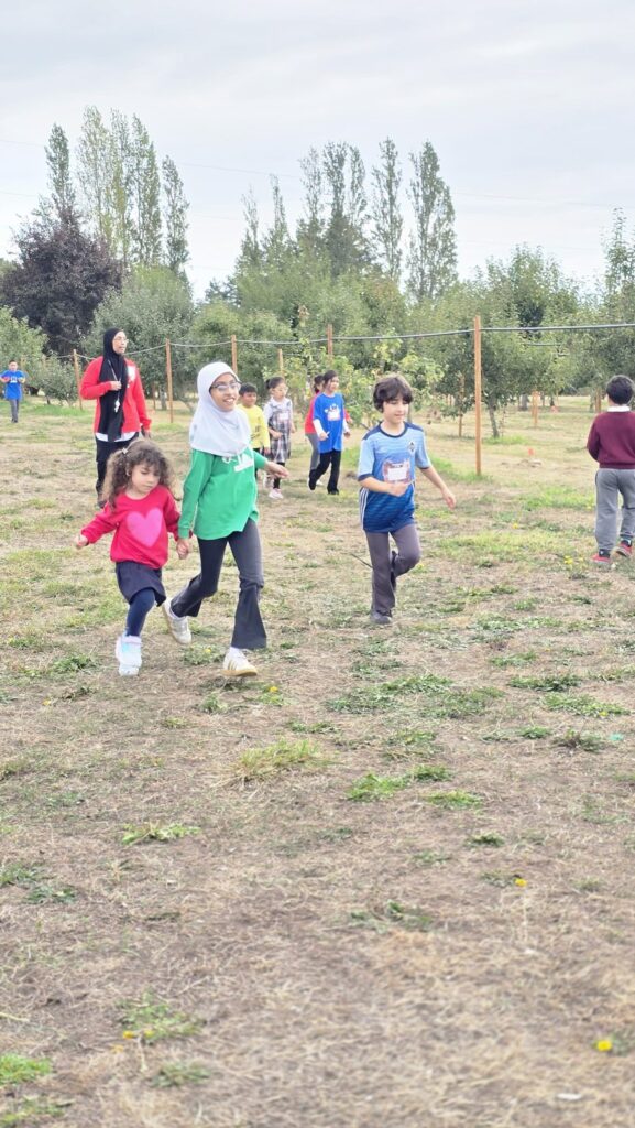 Students in House colours running together on the field